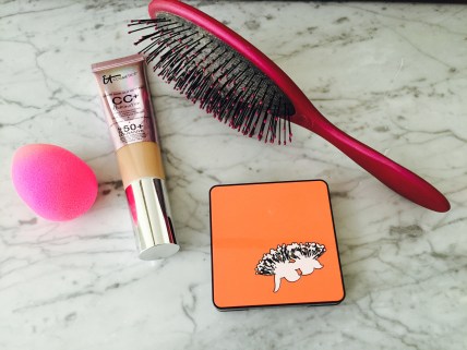 hair brush, bronzer , foundation and a makeup sponge